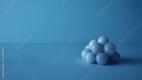 A minimalist composition featuring a pile of smooth pale blue eggs stacked in a pyramid shape against a solid blue background