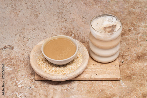 Coffee with sesame paste tahini in a cup on the Travertine table
