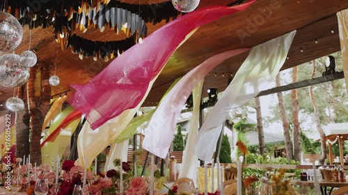 Elegant wedding decor featuring vibrant drapes, beautiful floral arrangements, and a stylish, inviting ambiance