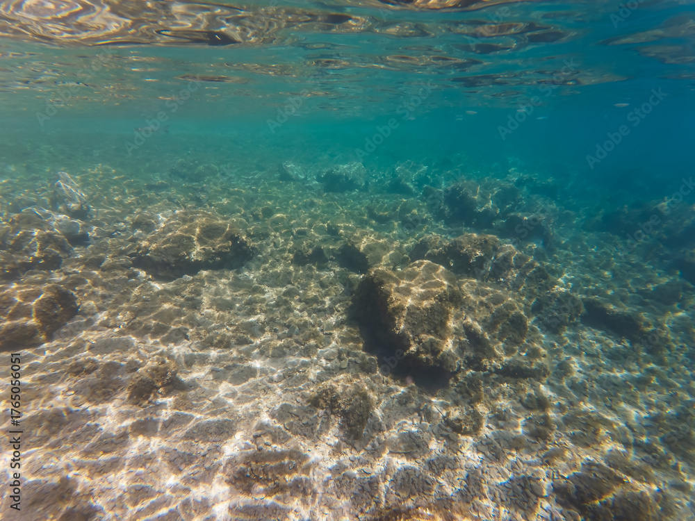 Fototapeta premium Underwater rocky seabed with clear turquoise water and sun rays in Calanques National Park, near Marseille, France.