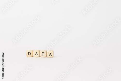 Wooden blocks spelling data on a clean white background, representing technology, finance, and the importance of information in modern business. copy space