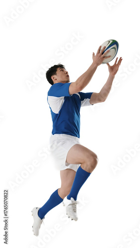 A male rugby player in action, jumping to catch a rugby ball during a game.