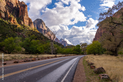 Scenic road winds through Zion National Park with sandstone cliffs.