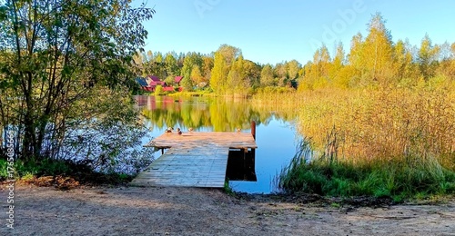 Wooden pier on the lake in autumn. Panoramic view