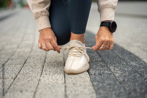 Canvas Print Person tying running shoe laces preparing for workout