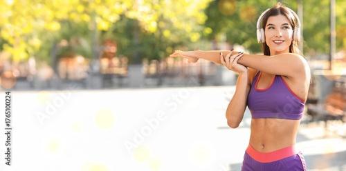 Sporty young woman stretchi...