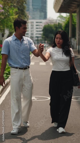 Romantic asian couple walking and holding hands