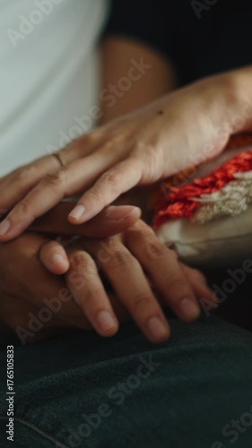 Loving couple gently holding and caressing hands