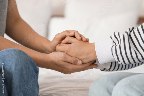 Canvas Print Young woman supporting her friend with suicidal thoughts in bedroom, closeup