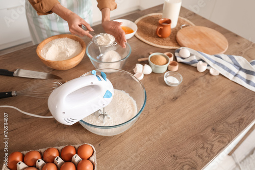 Young woman with mixer sift...