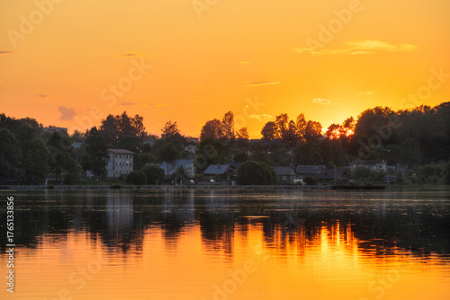 Fotografie Evening summer landscape with houses on the lake