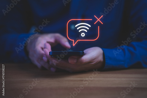 Close-up of hand holding smartphone with no Wi-Fi connection icon, symbolizing internet disconnection, network error, or poor signal, connectivity issues, technology problem, online failure concept.