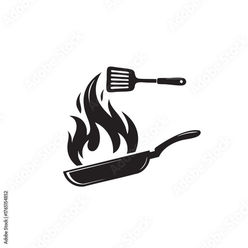 frying pan with spatula and flames
