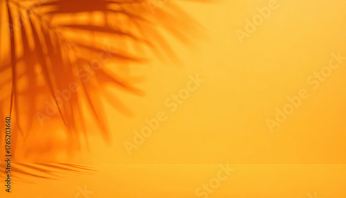 Blurred shadow from palm leaves on the orange wall. Minimal abstract background for product presentation. Spring and summer.