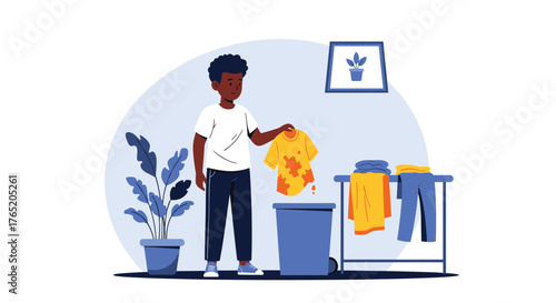 A young boy is tidying up his laundry and clothes.