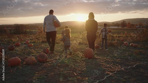 Family enjoying an afternoon at the pumpkin patch during sunset
