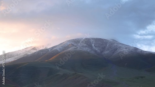 Sunrise time lapse of snowed hill in mongolia's altai mountain range