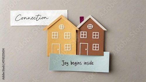 Two paper cutout houses overlapping with connection concept