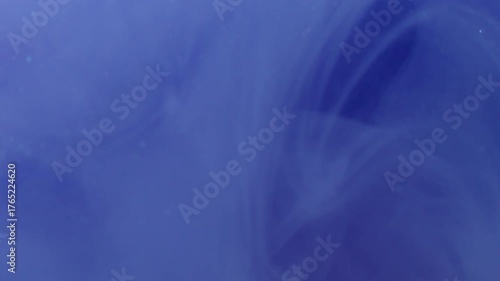 Mist paint. Steam flow. Blue purple violet pigment haze spiral dissolve in water. Art abstract curl ink blend color blur background.