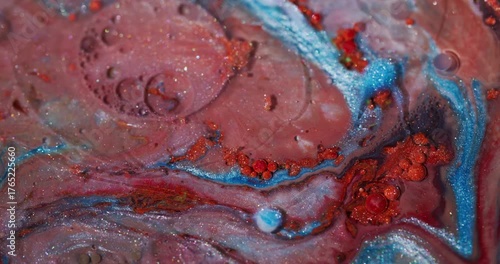 Glitter ink. Vibrant bubble. Blur red blue orange color oil water sparkling marble flow floating on abstract art acrylic background.