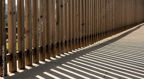 Wooden fence casting shadow lines, geometric interplay of light and form