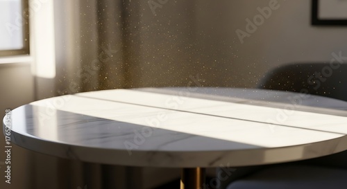 Sunlit marble table corner with dust particles reveals a serene, inviting interior ambiance and elegant design,