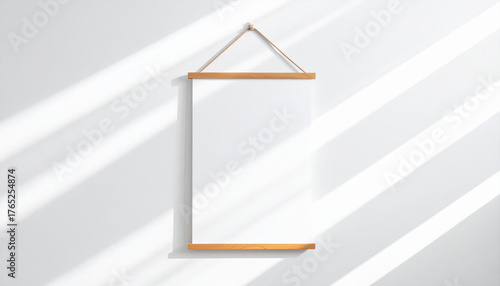 Art Display in Sunlight: A blank artwork display hung against a wall, adorned with a sunlit pattern, suggesting a gallery or home interior setting for creative expression and display.