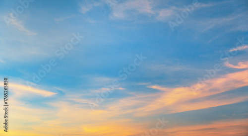 beautiful blue sky with  few clouds and  pinkish hue
