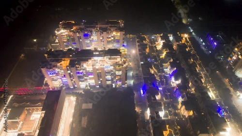 Aerial drone shot of buildings decorated with colourful lights for indian festival of diwali with fireworks in the air all around causing low lying smoke fog, smog air pollution that delhi is dealing