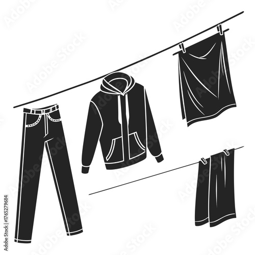 Black clothing items drying on a clothesline laundry