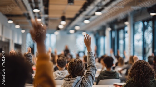 multicultural classroom. Hands raised in a classroom, indicating participation and engagement in a group discussion.