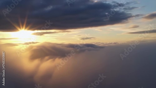 Dramatic cloudscape with god rays and glowing sun beams above the horizon. Seamless video loop. Generated AI