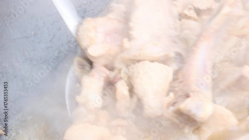simmer chopped onions and meat in oil in a cauldron
