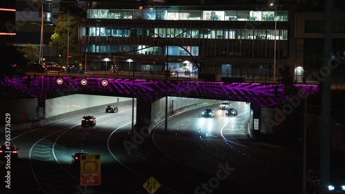 time-lapse cars driving under tunnel in city at night car lights long exposure