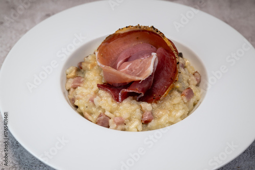 RECIPE FOR RISOTTO WITH BACON, MUSHROOMS, AND DRY-CURED HAM. High quality photo