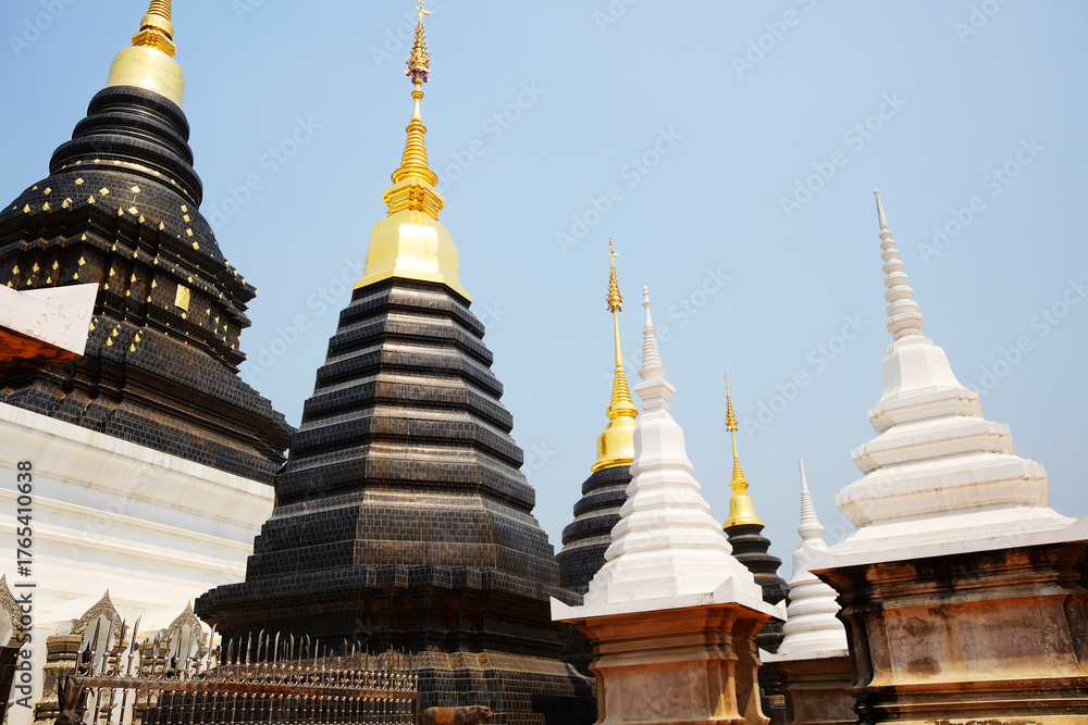 Fototapeta premium Ancient white and black with golden pagoda symbols of buddhism at Wat Den Sali Si Mueang Kaen temple in Chiang Mai Province in Thailand