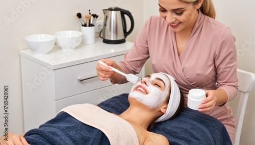 Beautician applying facial mask to a young woman in a spa salon for skin care and beauty treatment