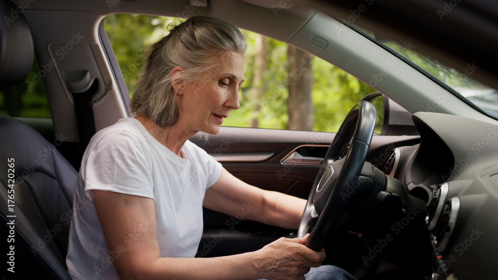 Obraz premium Angry frustrated disappointed Caucasian woman lady senior mature aged female client car driver in automobile can't start engine starting broken vehicle repair problem hit steering wheel anger annoyed