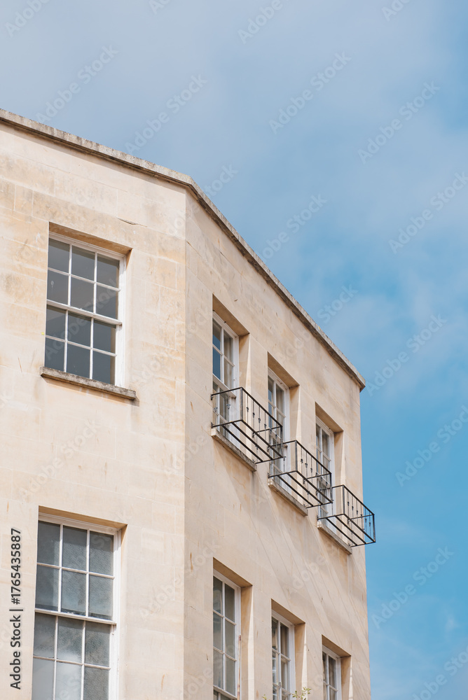 Fototapeta premium Brick building in the historic city with blue sky in background of Bath, UK, Showcasing its intricate architectural details and beauty.