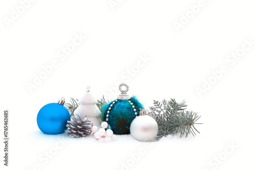 Christmas decorations and fir branches in fluffy snow. Copy space