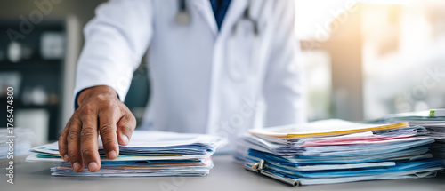 Healthcare consultation concept with doctor hand organizing medical document stack on desk in hospital office for patient treatment and diagnosis