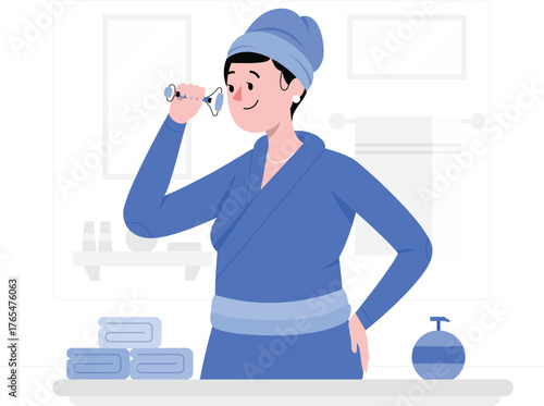 Woman applying facial roller in a bathroom with towels and soap dispenser beauty skincare