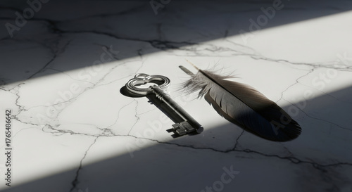 Antique key and dark feather on marble surface with dramatic lighting