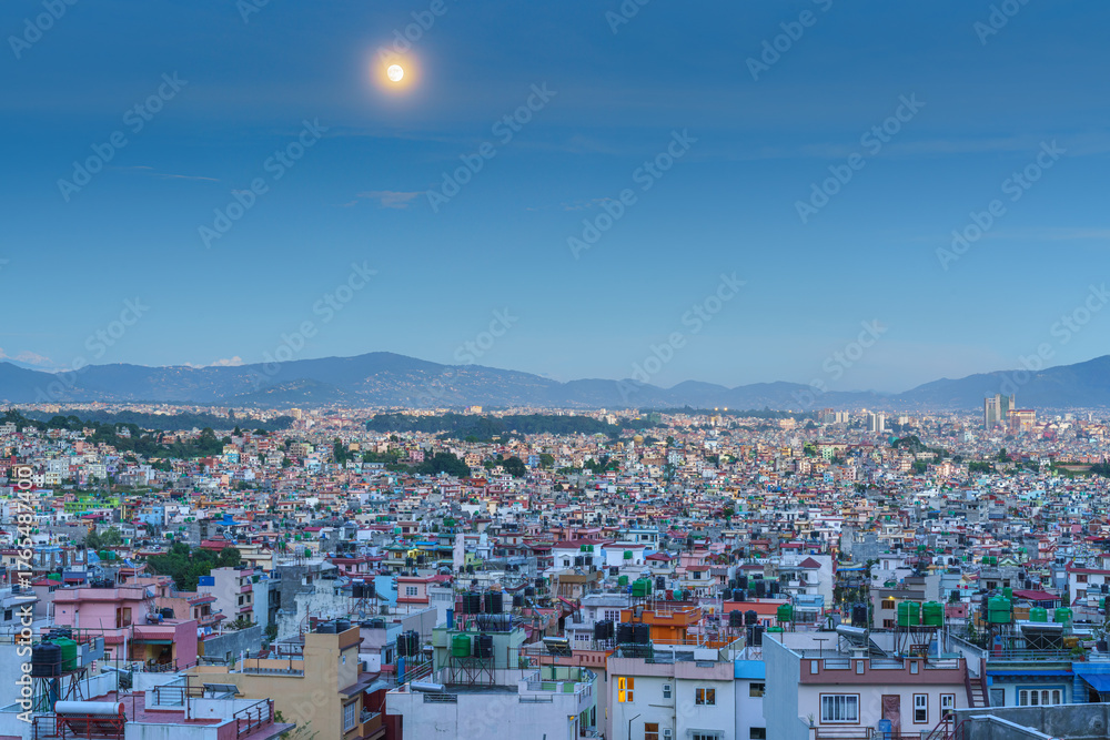 Fototapeta premium Cityscape under a full moon
