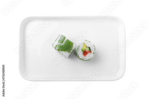 isolated sushi rolls with cabbage wrap and salmon filling on white plate