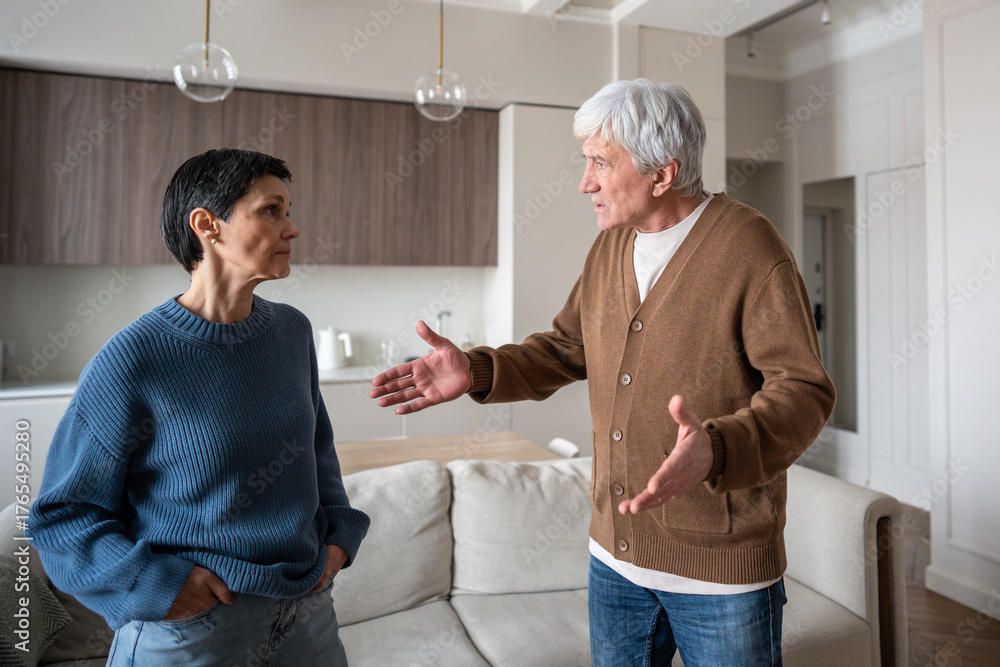 Obraz premium Irritated husband wife arguing, man waving arms during conflict. Relationship problem, marital argument, couple conflict, anger issue, domestic dispute and communication breakdown, emotional tension