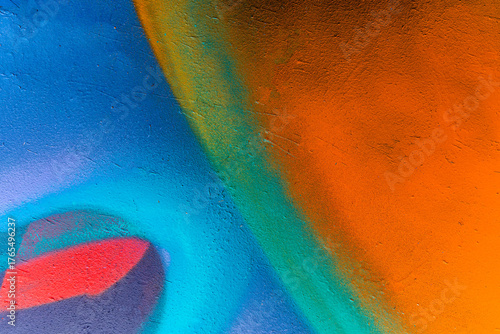 Beautiful brick wall colorful street art graffiti background. Abstract creative spray drawing fashion colors painting on the walls of the city. Urban Culture, aerosol texture