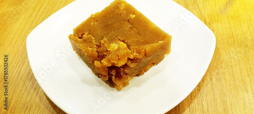 flour halva with hazelnuts on a white plate