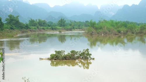 Flooded river with brown rushing water