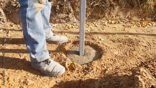 Obraz na płótnie setting posts in dry soil, properly setting fence posts in concretefilled holes